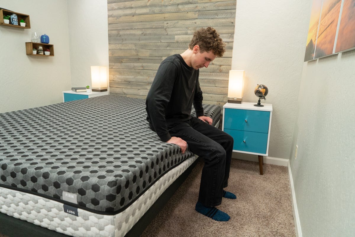 CNET staff testing the edge support of the Layla mattress